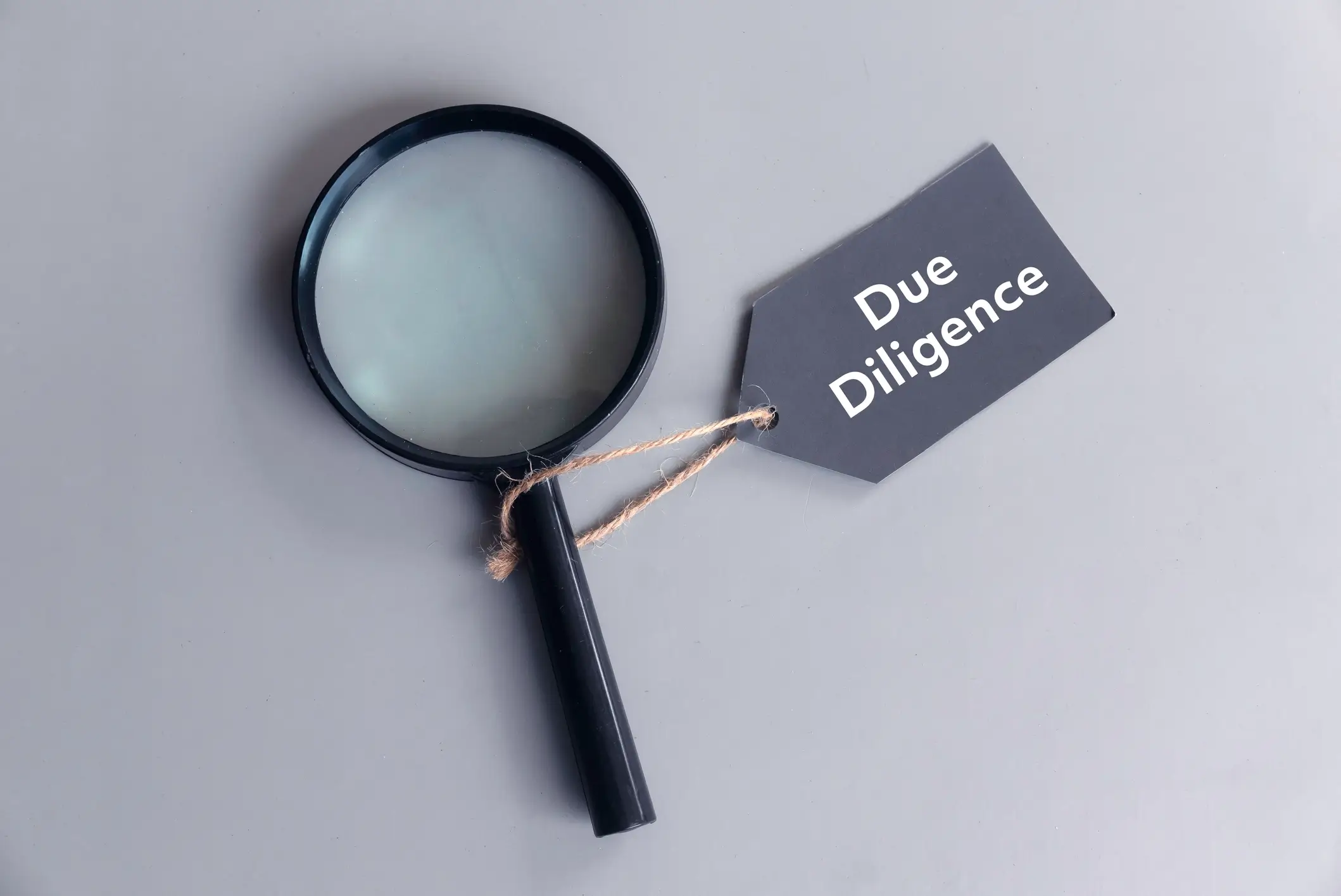 Magnifying glass with due diligence tag