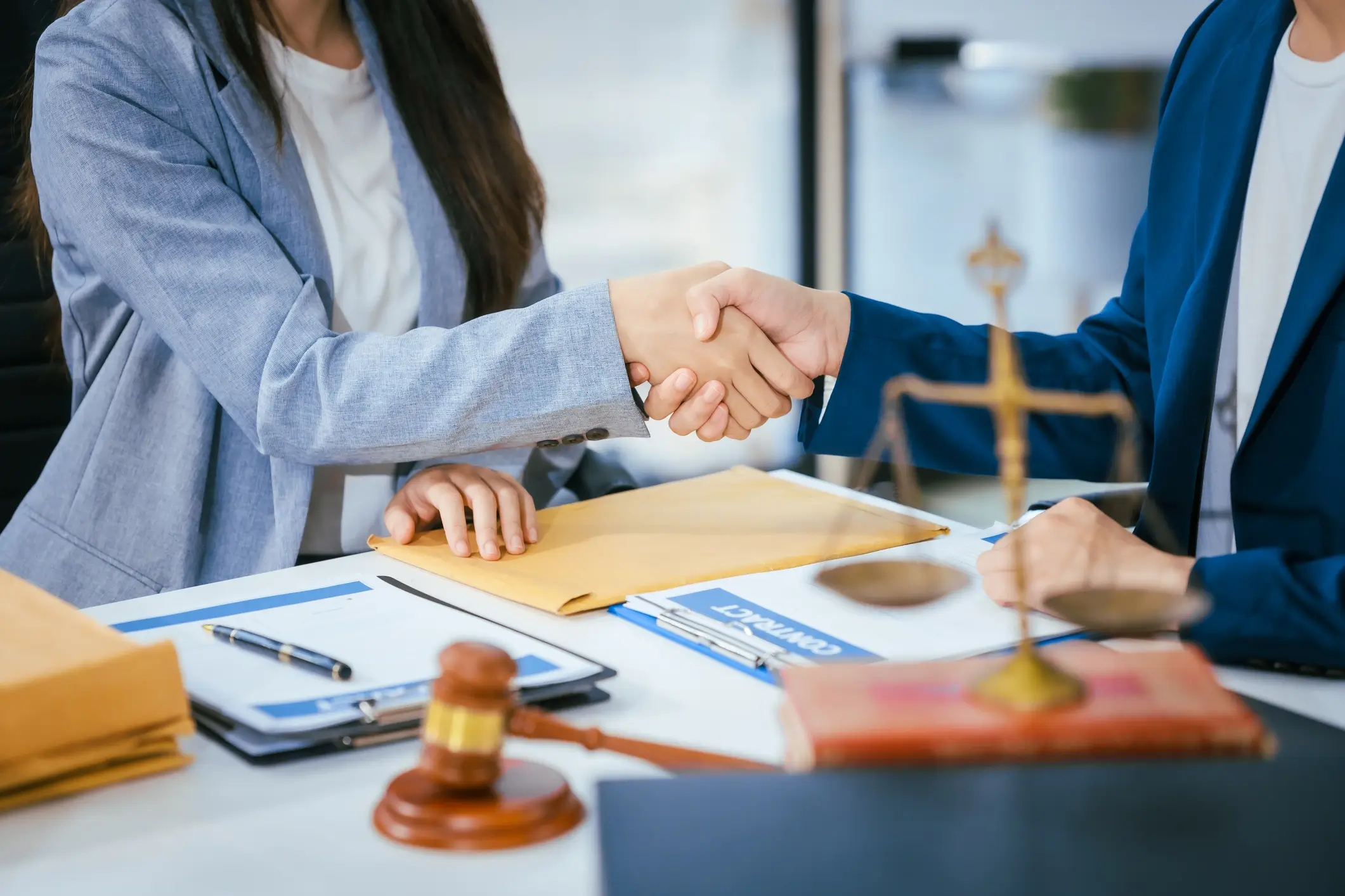 Lawyers shaking hands in an office