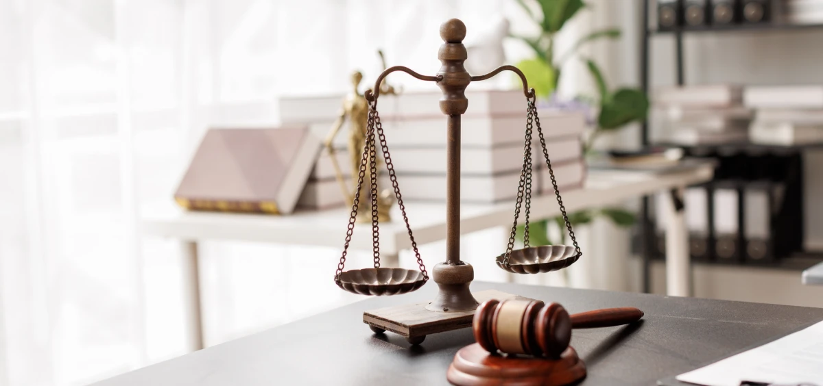 Scales of justice and gavel on desk